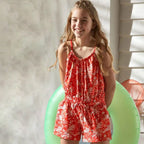 Organic cotton jumpsuit for girls, orange with white print 