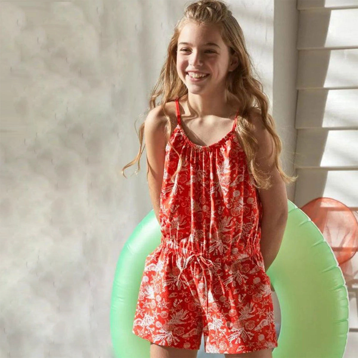 Organic cotton jumpsuit for girls, orange with white print 